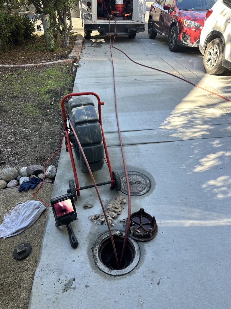 Sewer camera inspection being performed to locate drain line blockages cracks or sewer pipe damage